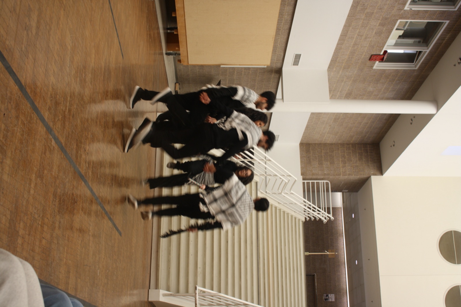 The PCO dabke line in keffiyehs crossing the hall at UNC Charlotte